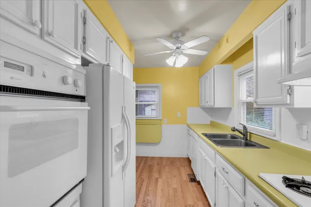 a kitchen with a sink a stove and cabinets