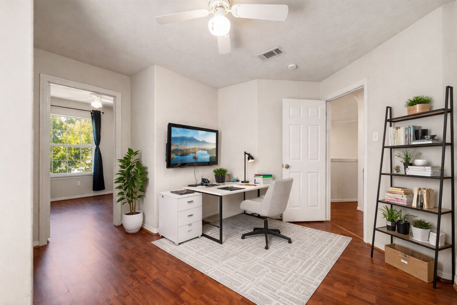 6418 England Street Houston, TX 77021 - Photo 12 of 29 a workspace with wooden floor and a bookshelf
