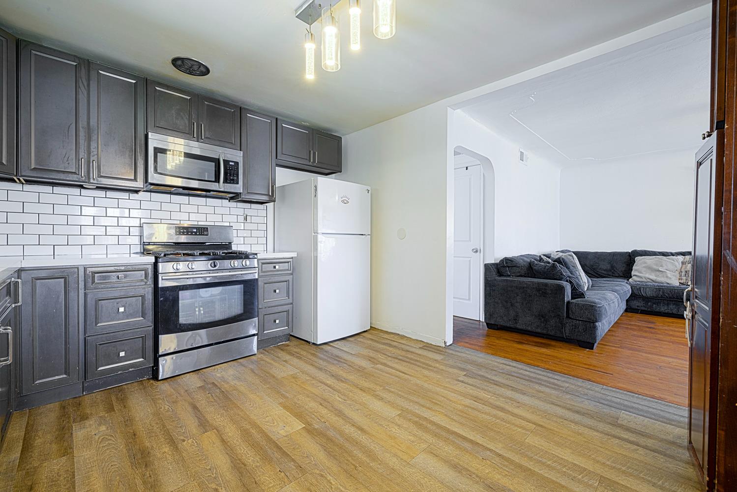 1030 Alpha Road Turlock, CA 95380 - Photo 13 of 25 a kitchen with stainless steel appliances a refrigerator a stove a microwave and cabinets