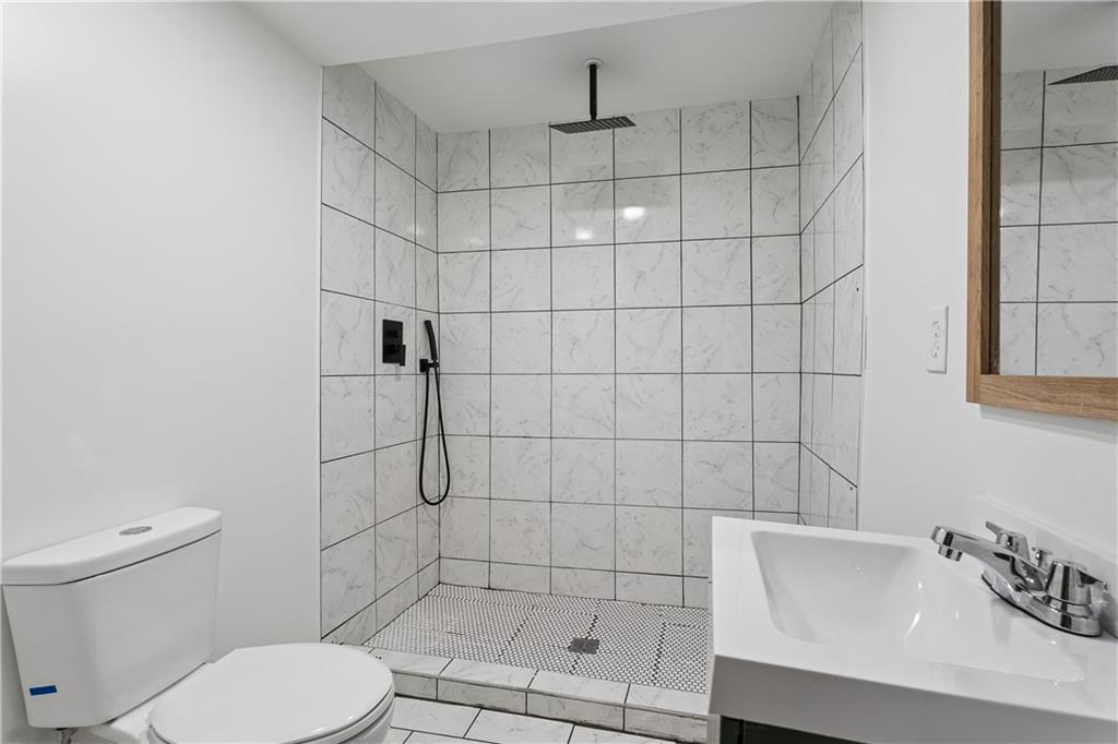 2526 Semmes Street Atlanta, GA 30344 - Photo 13 of 29 a bathroom with a toilet and shower