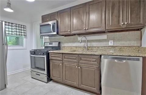 2526 Semmes Street Atlanta, GA 30344 - Photo 19 of 29 a kitchen with stainless steel appliances granite countertop a sink stove and microwave