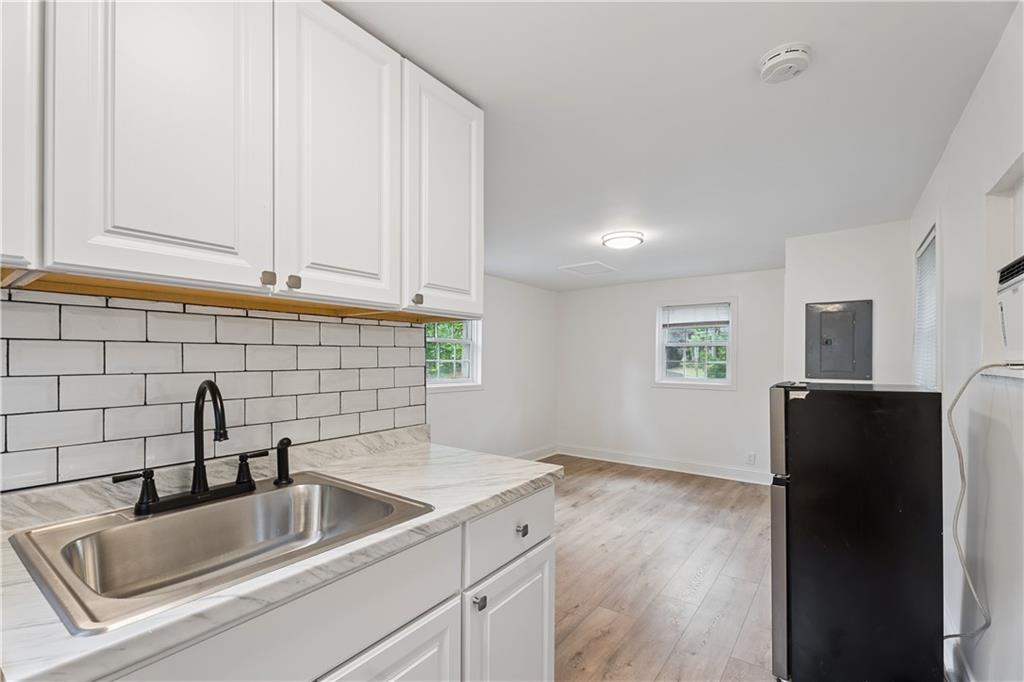2526 Semmes Street Atlanta, GA 30344 - Photo 7 of 29 a kitchen with a refrigerator sink and cabinets