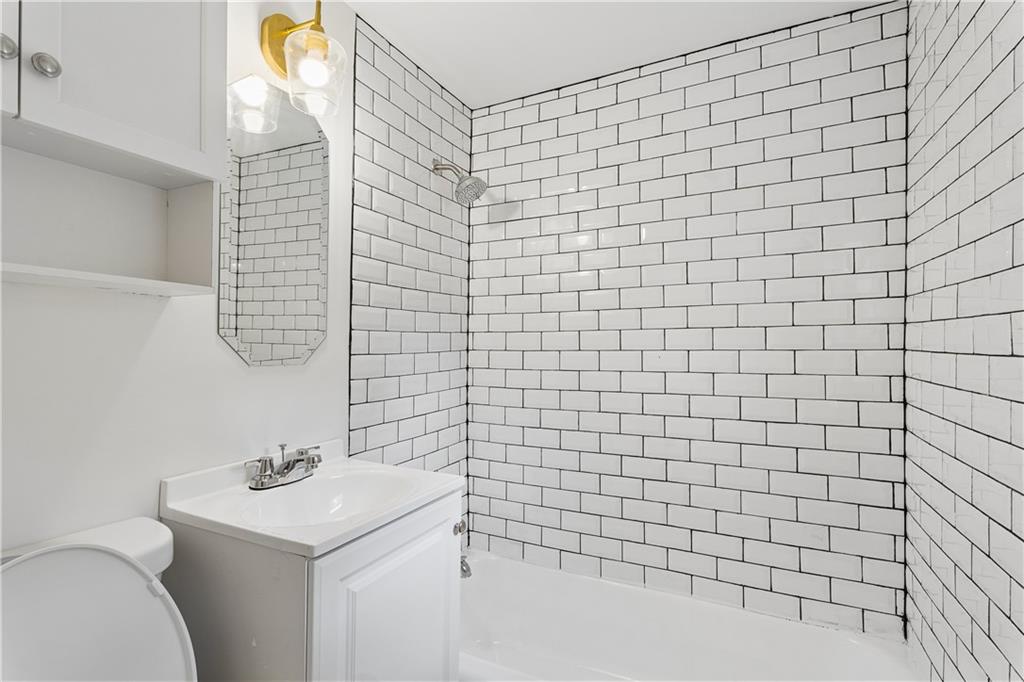 2526 Semmes Street Atlanta, GA 30344 - Photo 9 of 29 a bathroom with a sink a toilet and mirror