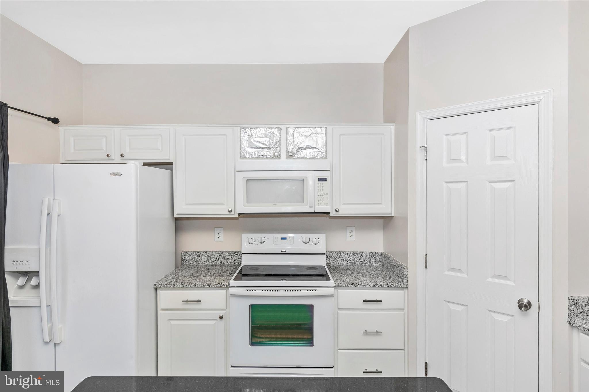 1742 Trestle Street Mount Airy, MD 21771 - Photo 26 of 58 a kitchen with a stove a refrigerator and a white cabinets