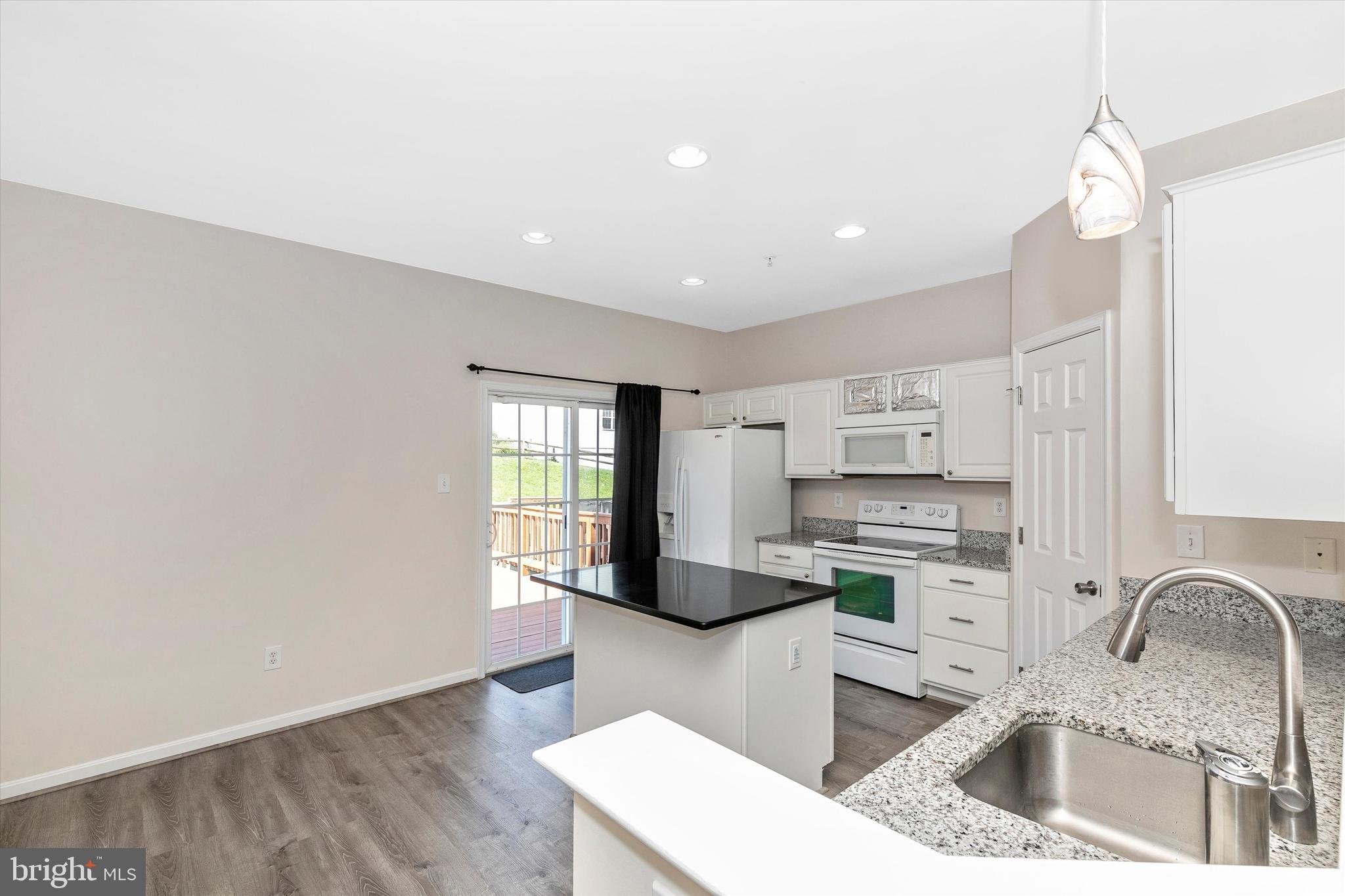 1742 Trestle Street Mount Airy, MD 21771 - Photo 28 of 58 a kitchen with stainless steel appliances a sink a stove a refrigerator cabinets and a window