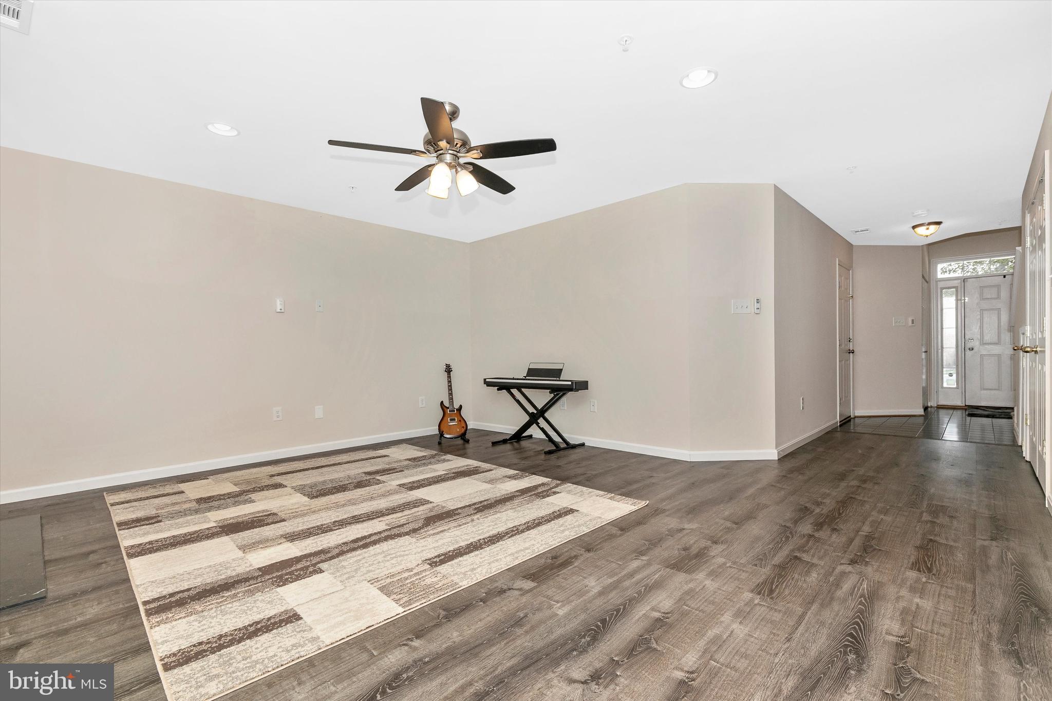 1742 Trestle Street Mount Airy, MD 21771 - Photo 8 of 58 a view of a livingroom with a hardwood floor and a ceiling fan