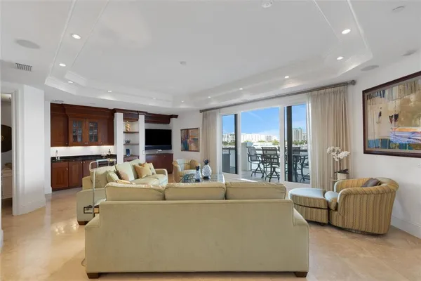 a dining room with furniture a chandelier and window