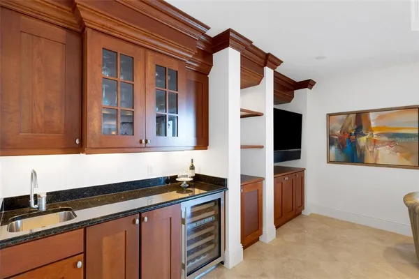 a kitchen with stainless steel appliances kitchen island granite countertop a stove a sink a refrigerator and chairs