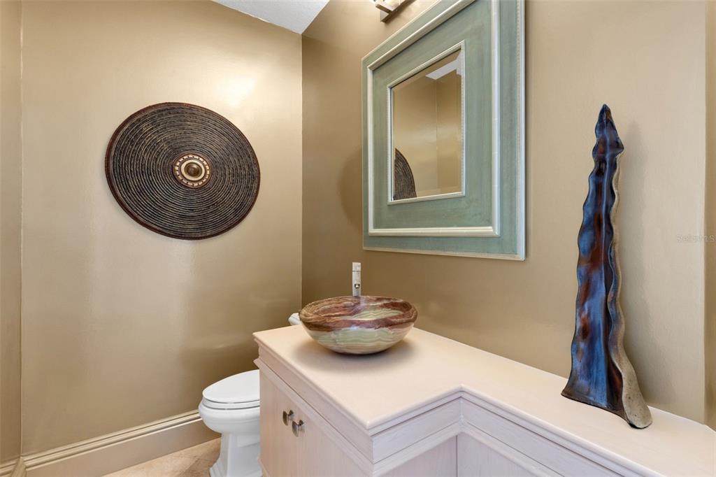 464 Golden Gate Point, Unit 403 Sarasota, FL 34236 - Photo 19 of 95 a bathroom with a toilet and a mirror