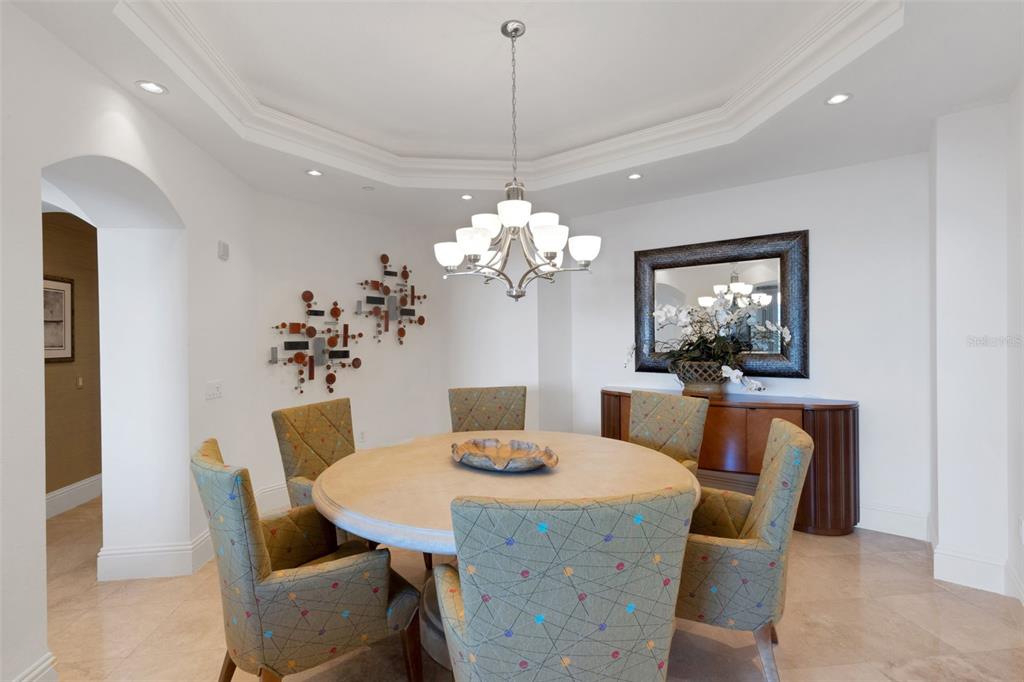 464 Golden Gate Point, Unit 403 Sarasota, FL 34236 - Photo 21 of 95 a dining room with furniture a chandelier and window