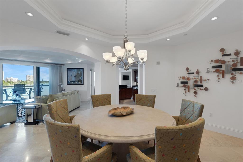 464 Golden Gate Point, Unit 403 Sarasota, FL 34236 - Photo 22 of 95 a view of a dining room with furniture and wooden floor