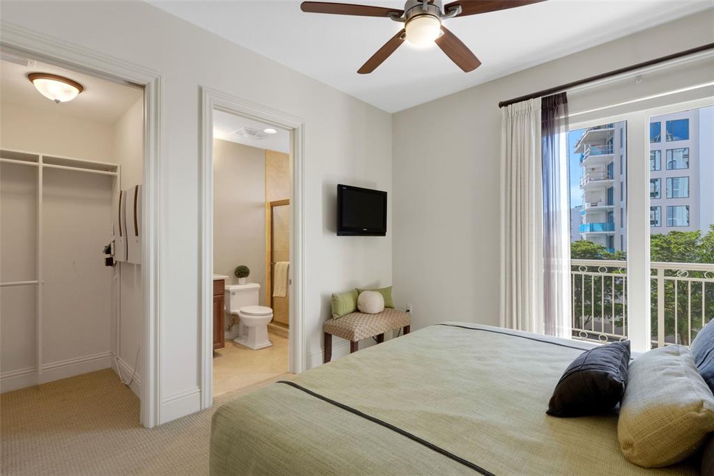 464 Golden Gate Point, Unit 403 Sarasota, FL 34236 - Photo 42 of 95 a bedroom with a bed and flat screen tv