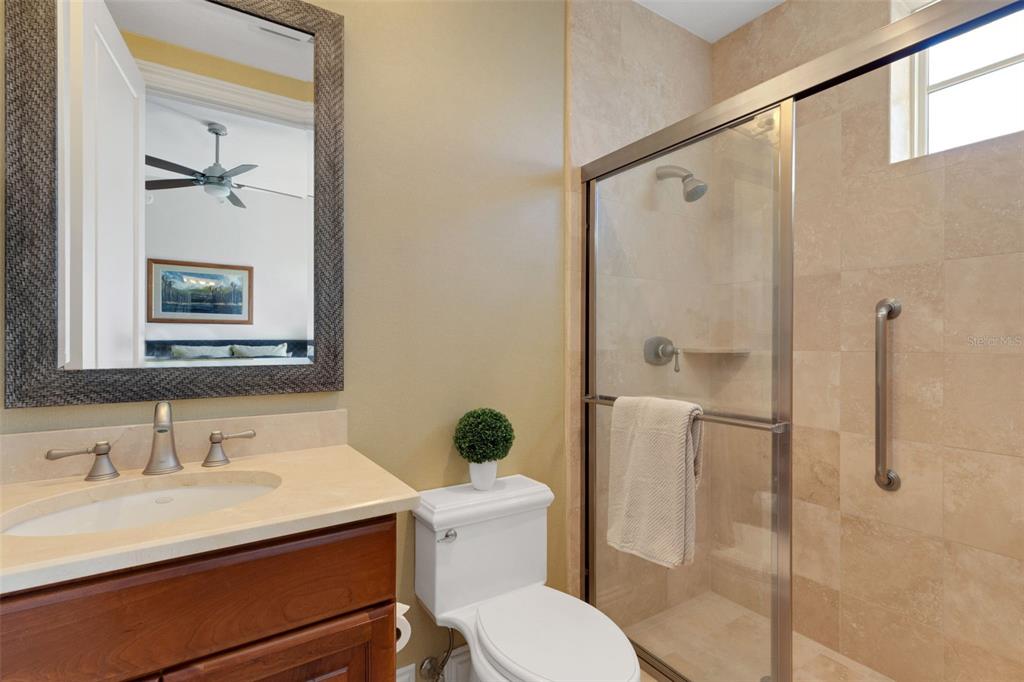464 Golden Gate Point, Unit 403 Sarasota, FL 34236 - Photo 46 of 95 a bathroom with a sink toilet and shower