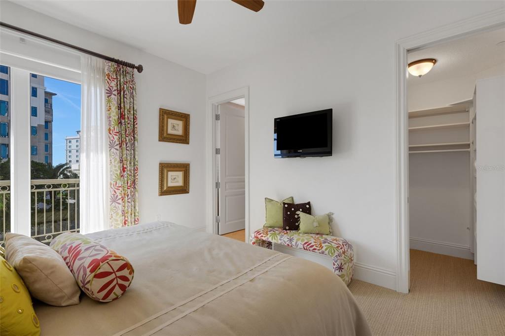 464 Golden Gate Point, Unit 403 Sarasota, FL 34236 - Photo 51 of 95 a bedroom with a bed and a flat screen tv