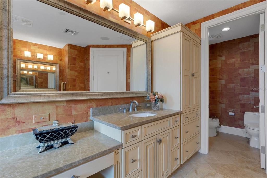 464 Golden Gate Point, Unit 403 Sarasota, FL 34236 - Photo 57 of 95 a bathroom with a sink a toilet a mirror and shower