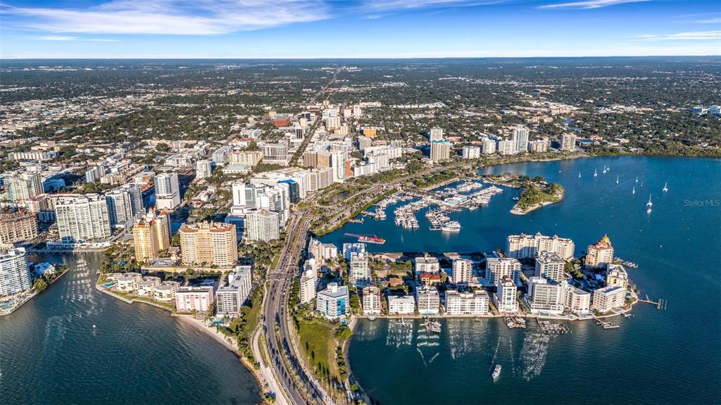 464 Golden Gate Point, Unit 403 Sarasota, FL 34236 - Photo 77 of 95 an aerial view of a city with lots of residential buildings ocean and mountain view in back