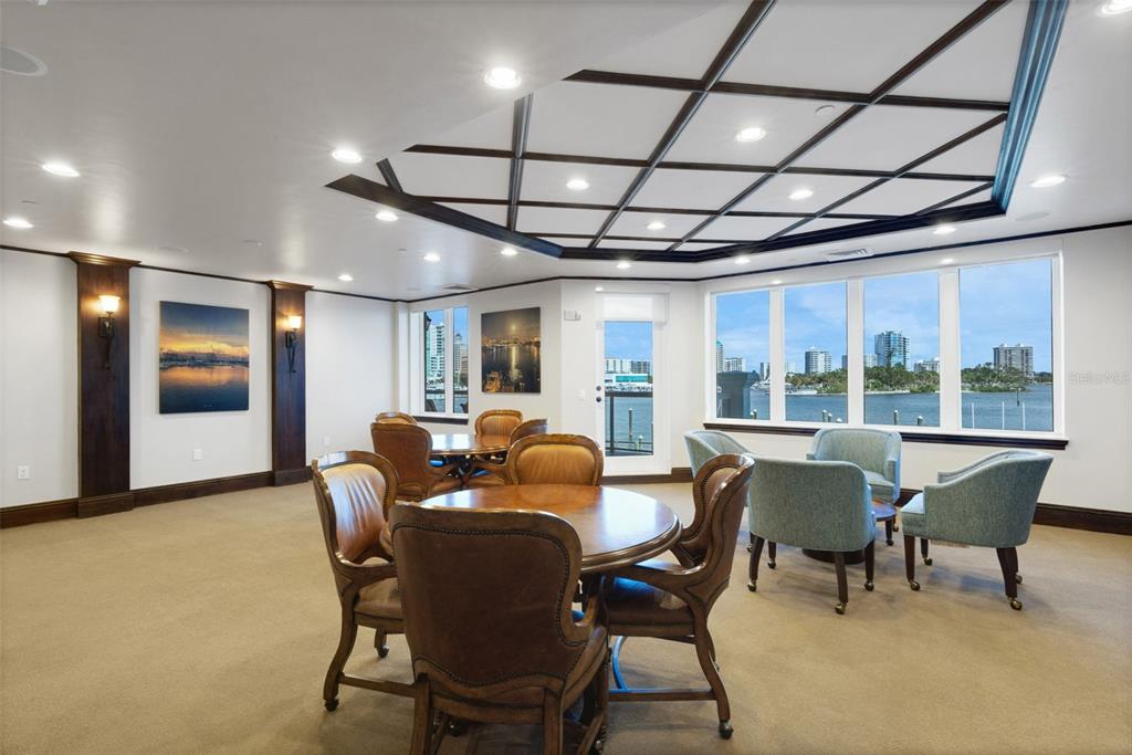 464 Golden Gate Point, Unit 403 Sarasota, FL 34236 - Photo 88 of 95 a dining room with furniture a chandelier and wooden floor