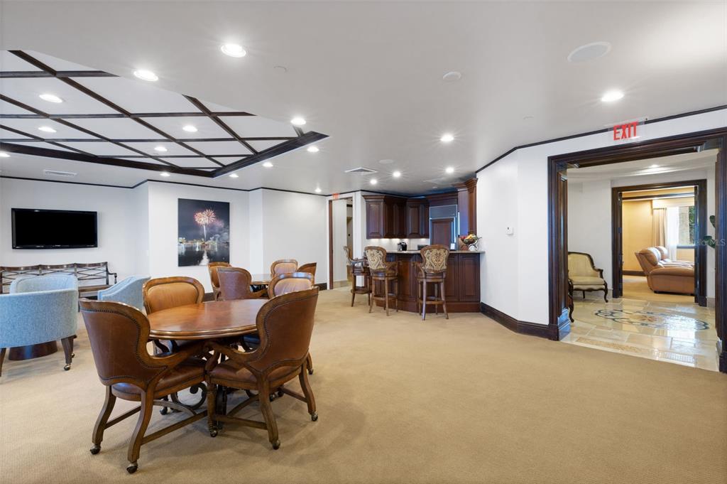 464 Golden Gate Point, Unit 403 Sarasota, FL 34236 - Photo 89 of 95 a dining room with furniture and a flat screen tv