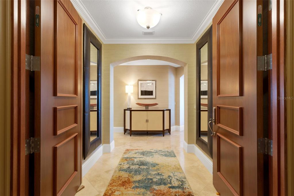 464 Golden Gate Point, Unit 403 Sarasota, FL 34236 - Photo 9 of 95 a view of a hallway with wooden floor and a living room