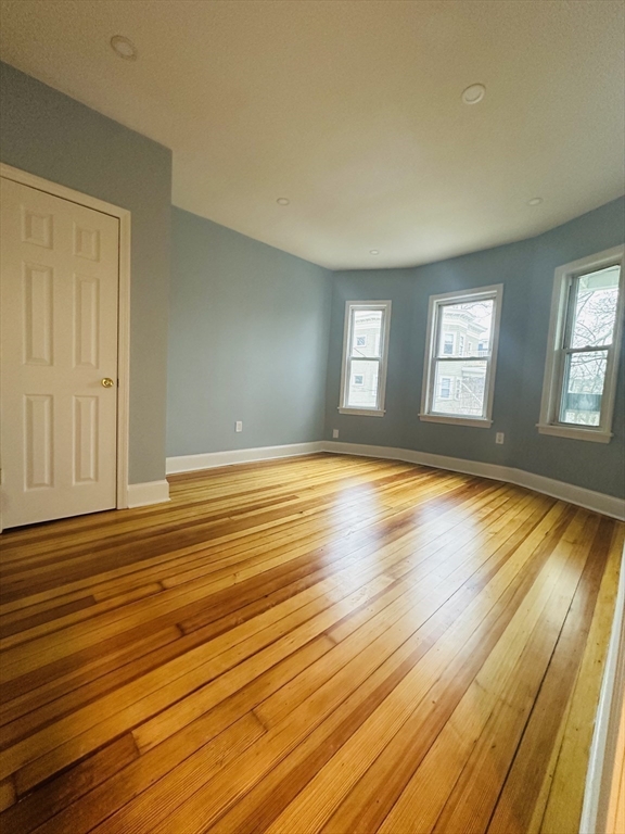 28 Melbourne Street, Unit 2 Boston, MA 02124 - Photo 13 of 27 a view of empty room with window and wooden floor
