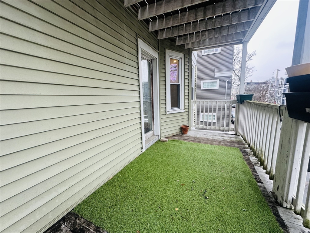 28 Melbourne Street, Unit 2 Boston, MA 02124 - Photo 22 of 27 a view of backyard with barbeque grill and wooden fence