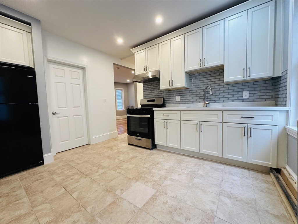 28 Melbourne Street, Unit 2 Boston, MA 02124 - Photo 5 of 27 a large kitchen with cabinets