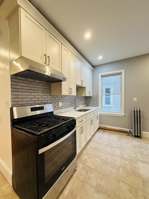 28 Melbourne Street, Unit 2 Boston, MA 02124 - Photo 7 of 27 a kitchen with granite countertop a stove sink and cabinets