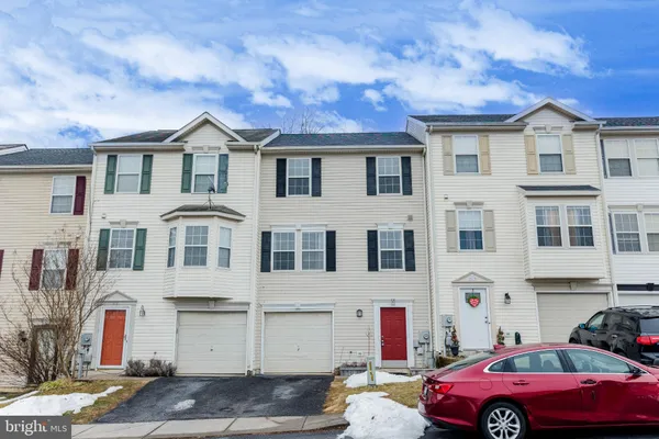 a front view of a house with parking space