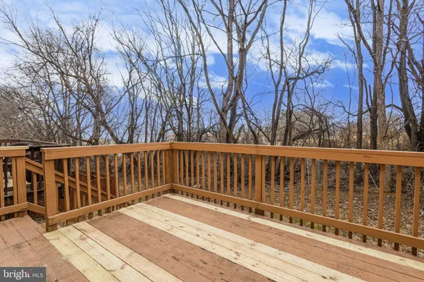 a balcony with wooden floor and fence