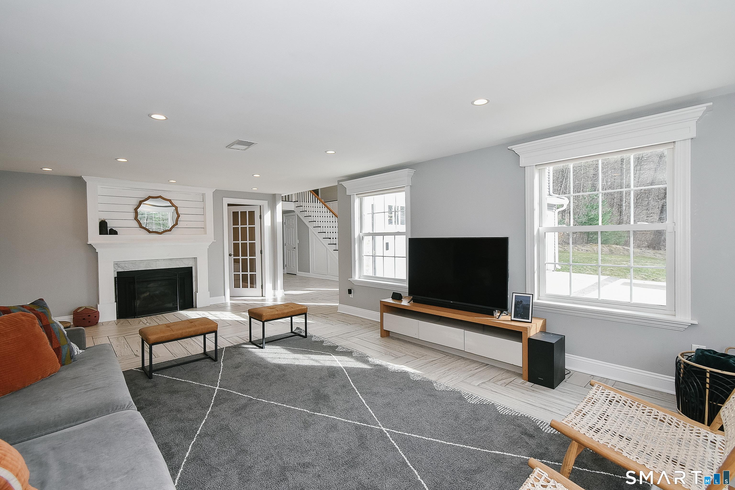 50 1/2 Mountain Spring Road Farmington, CT 06032 - Photo 5 of 28 a living room with furniture a fireplace and a flat screen tv