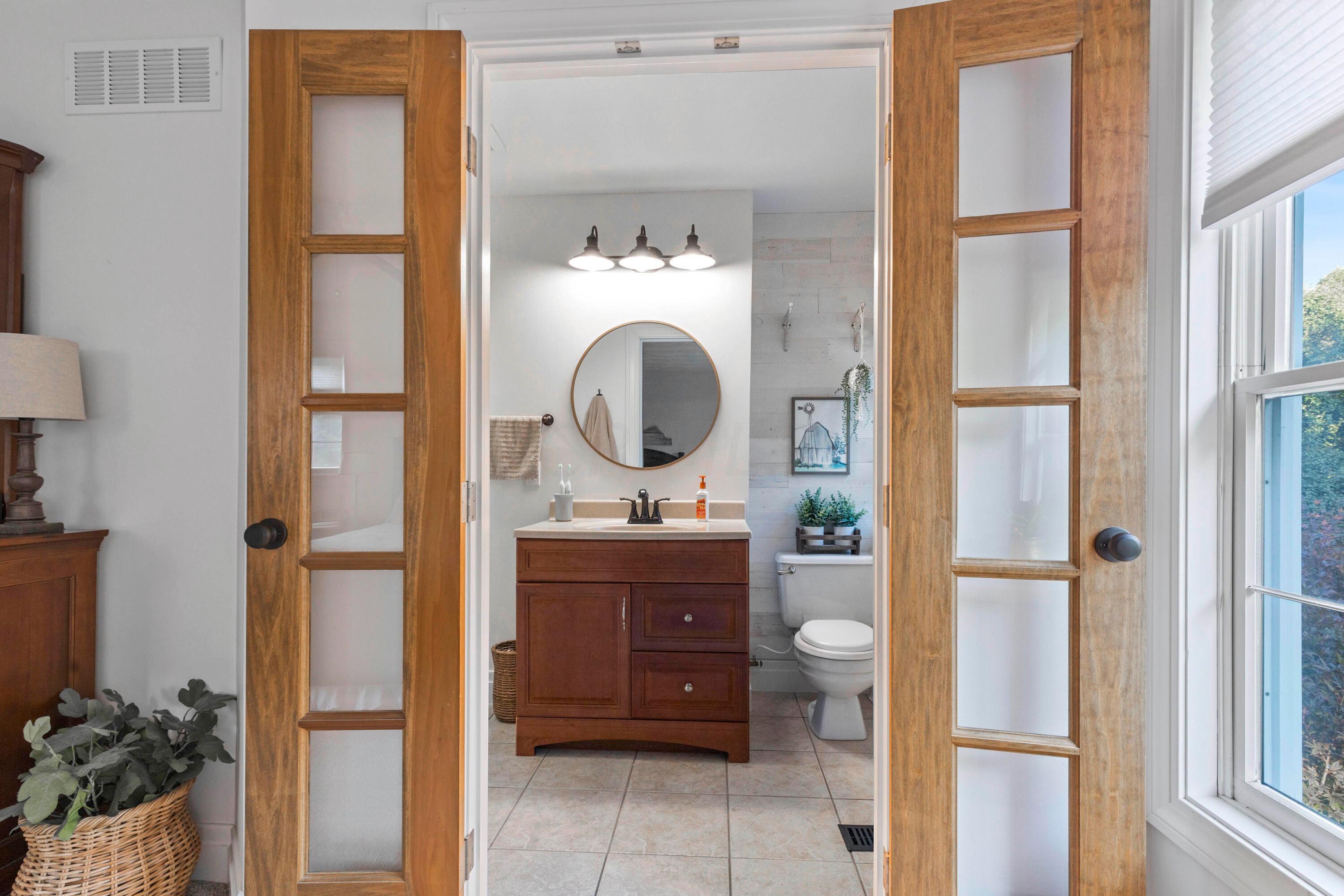 6262 Duffy Road Delaware, OH 43015 - Photo 37 of 96 • Ceramic tile flooring
• White painted walls with
shiplap accent wall
• Enclosed vanity with
single bowl, cultured
marble sinktop
• 3 bulb wall light
• (3) goose neck lights
• Shower stall with
glass door
• Ceiling exhaust