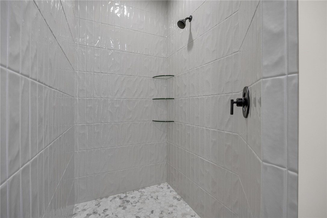 1230 Melton Road, Unit 216 West Union, SC 29696 - Photo 25 of 49 A sleek, contemporary shower with textured tiling and convenient glass corner shelves awaits.