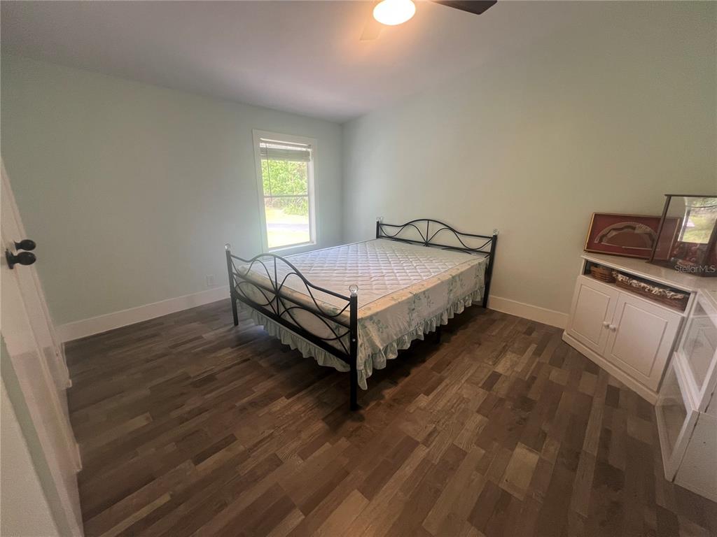 5855 Jack Brack Road St. Cloud, FL 34771 - Photo 67 of 86 a bed sitting in a room next to a window