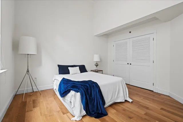 a bedroom with a bed and a lamp