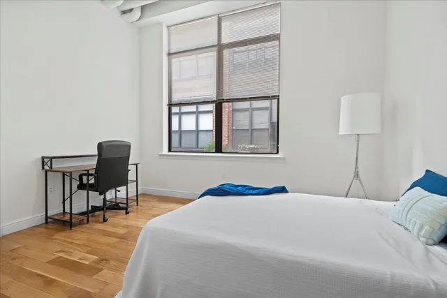 a bedroom with a bed and a window