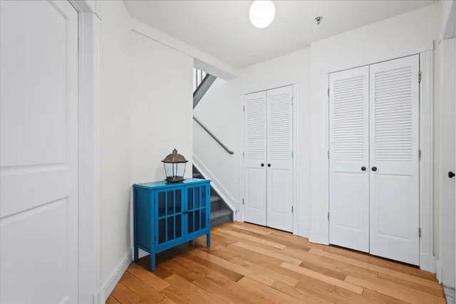 a view of empty room with wooden floor