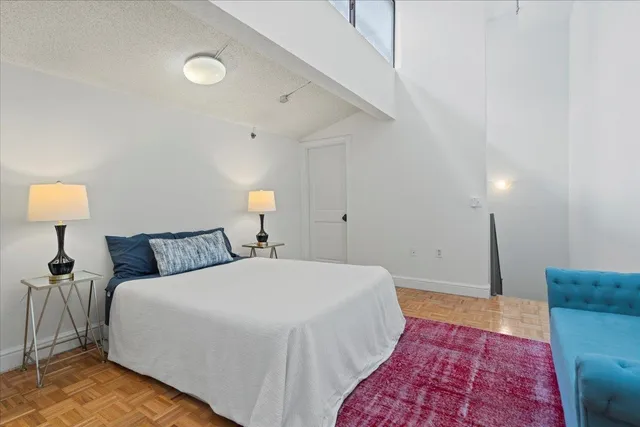 a bed room with a bed and a lamp