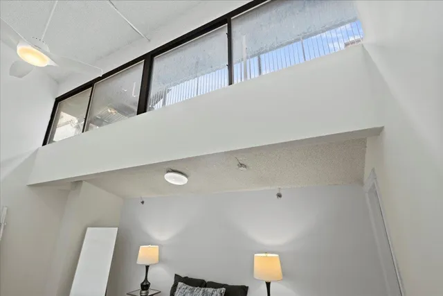 a view of a room with a white wall and wooden floor
