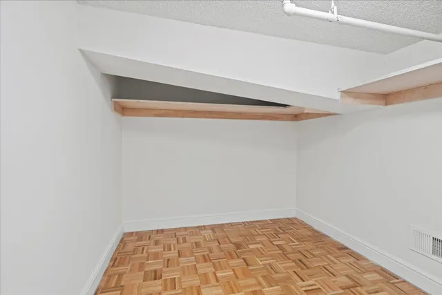 a view of staircase with wooden floor and white walls