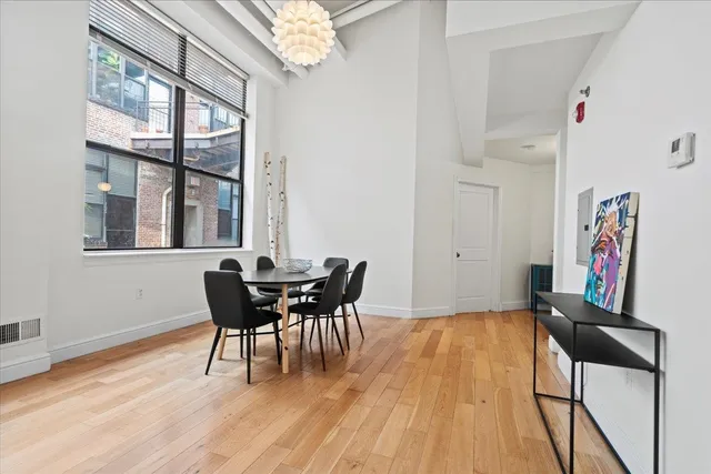 a view of a dining room with furniture window and wooden floor