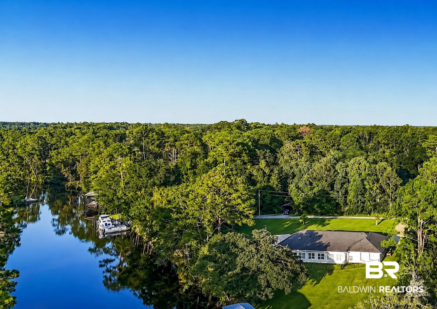 9825 Wolf Creek Ridge Elberta, AL 36530 - Photo 72 of 76 Waterfront property featuring a private boat dock, lush green lawns, and mature trees