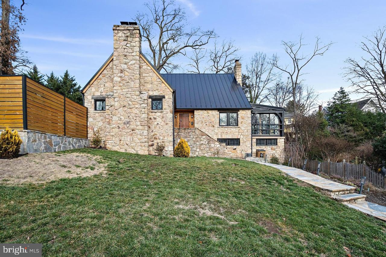 2347 South Arlington Ridge Road Arlington, VA 22202 - Photo 1 of 42 Charming stone home with lush greenery.