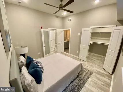 a bed room with a bed and a large window