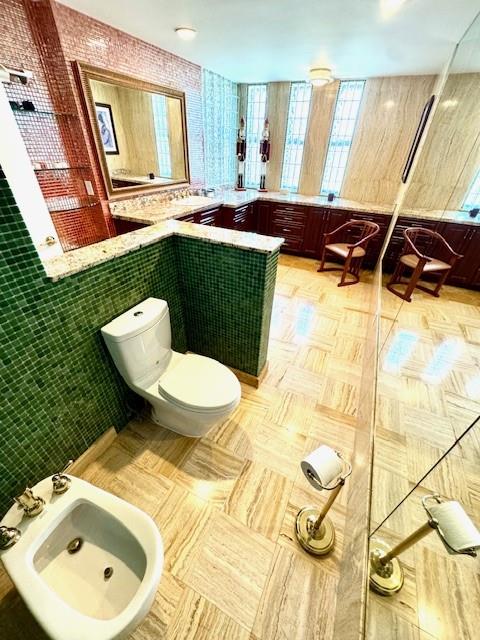 1540 Northeast Quayside Terrace, Unit D1 Miami, FL 33138 - Photo 36 of 45 a bathroom with a sink a toilet and a mirror