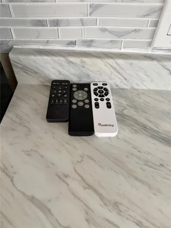 a kitchen with white cabinets and sink