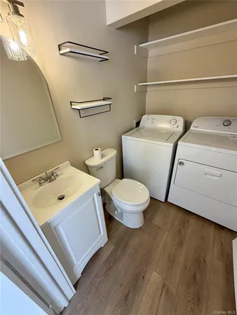 a white toilet sitting next to a bathroom sink