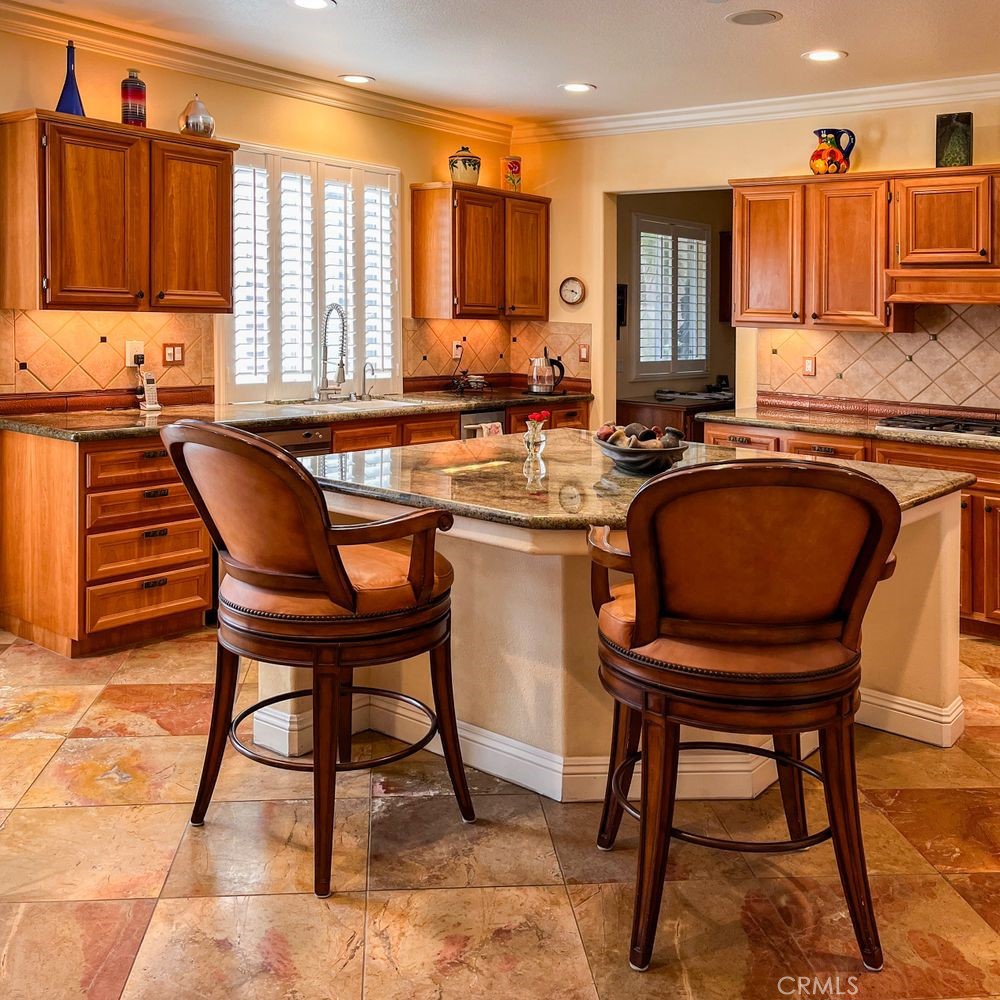 27 Mountain Laurel Way Azusa, CA 91702 - Photo 15 of 39 a kitchen with a table chairs sink and cabinets