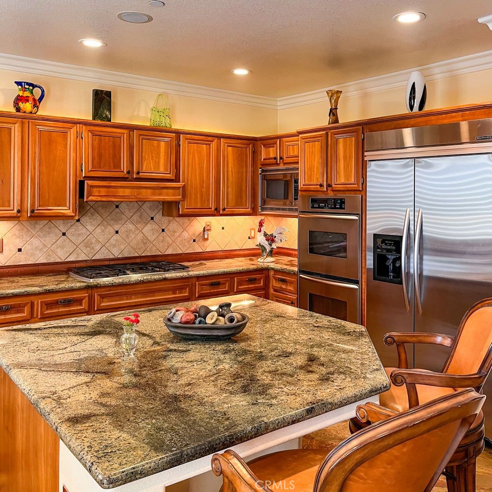 27 Mountain Laurel Way Azusa, CA 91702 - Photo 18 of 39 a kitchen with stainless steel appliances granite countertop a sink and cabinets