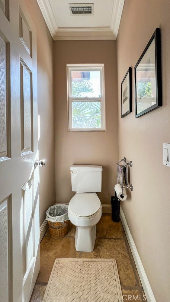 27 Mountain Laurel Way Azusa, CA 91702 - Photo 30 of 39 a bathroom with a toilet and a painting on the wall