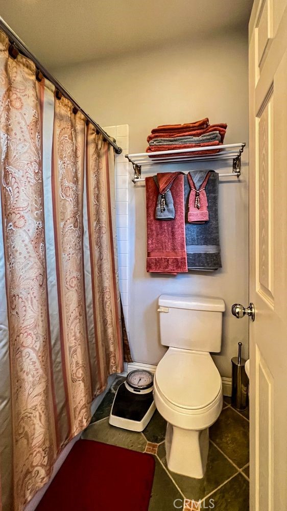 27 Mountain Laurel Way Azusa, CA 91702 - Photo 34 of 39 a bathroom with a toilet and a shower curtain